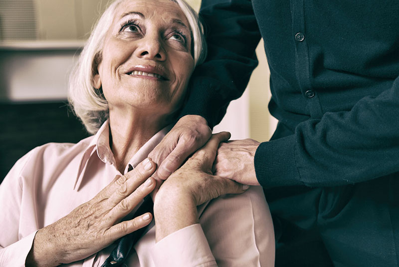 senior woman taking her husband's hand