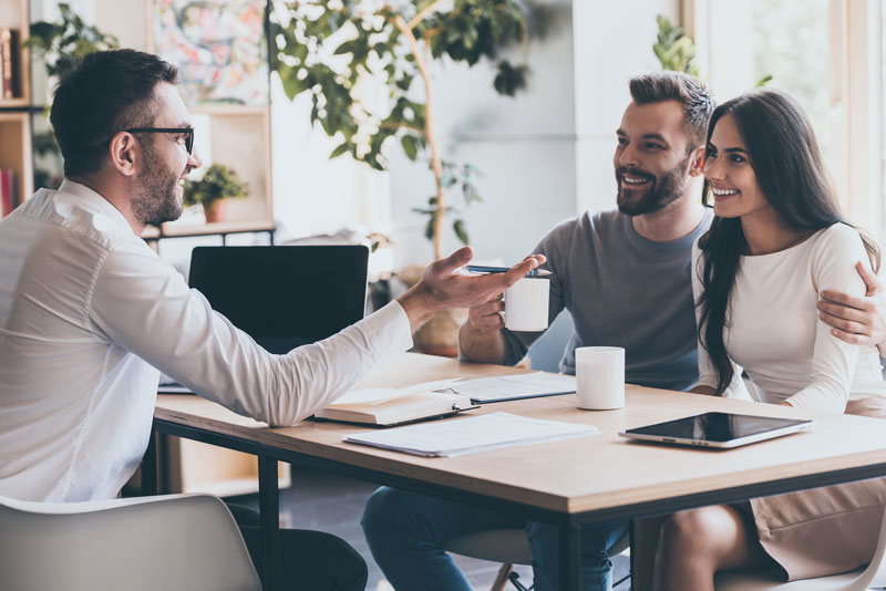 a couple talking to an agent