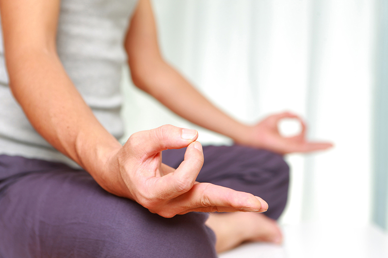 a woman meditating in the home