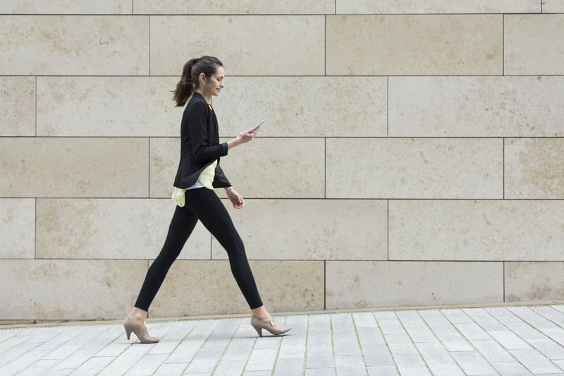 woman walking on her phone